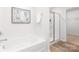 Bright bathroom featuring a soaking tub, glass-enclosed shower, and modern fixtures at 111 Rustling Waters Dr, Mooresville, NC 28117