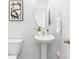 Clean, modern bathroom featuring a pedestal sink, minimalist decor, and neutral color scheme at 111 Rustling Waters Dr, Mooresville, NC 28117