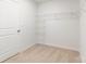Walk-in closet featuring carpeted floors and white shelving at 111 Rustling Waters Dr, Mooresville, NC 28117