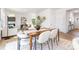 Bright dining room featuring a wood table, white chairs, a decorative rug, and an open-concept design at 111 Rustling Waters Dr, Mooresville, NC 28117