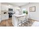 Modern kitchen features white cabinets, stainless steel appliances, and a quartz countertop island at 111 Rustling Waters Dr, Mooresville, NC 28117
