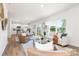 Open living room and kitchen area with hardwood floors, natural light, and stylish furnishings at 111 Rustling Waters Dr, Mooresville, NC 28117