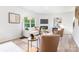 Inviting living room with a fireplace, large window, modern furnishings, and warm color palette at 111 Rustling Waters Dr, Mooresville, NC 28117
