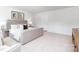 Bright bedroom featuring neutral tones, comfortable seating, carpet flooring and ample natural light at 111 Rustling Waters Dr, Mooresville, NC 28117