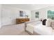 Calm bedroom featuring neutral tones, comfortable seating, a wood dresser, and ample natural light at 111 Rustling Waters Dr, Mooresville, NC 28117