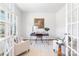 Bright home office features French doors, neutral walls, stylish decor, and comfortable seating at 111 Rustling Waters Dr, Mooresville, NC 28117