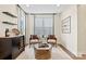 Cozy living room with modern furniture, wine rack, and natural light streaming through the window at 1115 Sugar Creek Rd, Indian Land, SC 29707