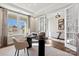 Bright home office with ample natural light, stylish desk, and decorative glass doors at 1115 Sugar Creek Rd, Indian Land, SC 29707