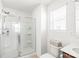 Bright bathroom features a walk-in shower with glass door, vanity, and neutral finishes at 112 Buoy Ln, Statesville, NC 28677
