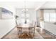 Charming dining room with stylish chandelier, hardwood floors, and backyard access at 112 Buoy Ln, Statesville, NC 28677