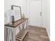 Neutral entryway with a wooden console table, decorative lamp, and framed artwork, with wood flooring at 112 Buoy Ln, Statesville, NC 28677