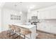 Stylish kitchen featuring white cabinets, a center island with bar seating, stainless steel appliances, and pendant lighting at 112 Buoy Ln, Statesville, NC 28677