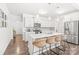 Bright, modern kitchen with stainless steel appliances, white cabinetry, quartz countertops, and an island with seating at 112 Buoy Ln, Statesville, NC 28677