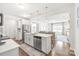 Open-concept kitchen featuring a central island with seating and stainless steel appliances with an open view to the living area at 112 Buoy Ln, Statesville, NC 28677