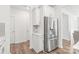 Bright kitchen area with white cabinetry, a stainless steel refrigerator, and a tiled backsplash, for modern style at 112 Buoy Ln, Statesville, NC 28677