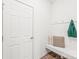 Bright mud room featuring a built-in bench with storage, coat hooks, and a conveniently placed exterior door at 112 Buoy Ln, Statesville, NC 28677