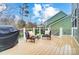 View of the home's lovely back deck with grill, chairs and table at 1126 Snowbird Ln, Waxhaw, NC 28173