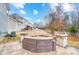 Inviting backyard featuring a stone sitting area and partial view of the yard at 1126 Snowbird Ln, Waxhaw, NC 28173