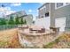 Enjoyable backyard area with comfortable seating, firepit, and views of the home's exterior at 1126 Snowbird Ln, Waxhaw, NC 28173