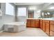 Bathroom featuring a soaking tub, double vanity with mirror, and tile flooring at 1126 Snowbird Ln, Waxhaw, NC 28173