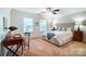 Bright bedroom with a comfortable bed, desk, and large windows at 1126 Snowbird Ln, Waxhaw, NC 28173