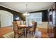 Formal dining area with natural light, decorative chandelier, and classic furniture at 1126 Snowbird Ln, Waxhaw, NC 28173