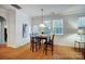 Dining room featuring a chandelier, wood floors, and natural light from the windows at 1126 Snowbird Ln, Waxhaw, NC 28173