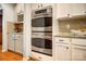 Close-up of the stainless-steel double oven and white cabinets at 1126 Snowbird Ln, Waxhaw, NC 28173