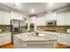 Bright kitchen featuring granite countertops, stainless steel appliances, and white cabinetry at 1126 Snowbird Ln, Waxhaw, NC 28173