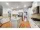 Spacious kitchen featuring white cabinetry, stainless appliances, granite countertops, and hardwood floors at 1126 Snowbird Ln, Waxhaw, NC 28173