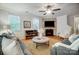 Spacious living area with a cozy seating arrangement, fireplace, and natural light at 1126 Snowbird Ln, Waxhaw, NC 28173