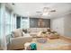 Comfortable living room area with a large sectional sofa, fan, and plenty of sunlight at 1126 Snowbird Ln, Waxhaw, NC 28173