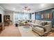 Inviting living room with a large sectional sofa, ceiling fan, and plenty of natural light at 1126 Snowbird Ln, Waxhaw, NC 28173