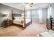 Main bedroom with large windows, neutral walls, and a four-poster bed at 1126 Snowbird Ln, Waxhaw, NC 28173
