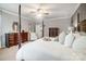 Spacious main bedroom featuring a four-poster bed, ceiling fan, and ample natural light at 1126 Snowbird Ln, Waxhaw, NC 28173