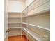 Walk-in pantry featuring wire shelving and wood floors at 1126 Snowbird Ln, Waxhaw, NC 28173