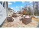 Spacious outdoor patio with stone base, outdoor furniture, and a view of the yard at 1126 Snowbird Ln, Waxhaw, NC 28173