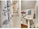 Cozy bathroom features a standing shower with grab bars, pedestal sink, and wood-look floors at 119 Hemphill Ave, Chester, SC 29706