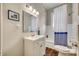 Bathroom with a white vanity, mirror, decorative lighting, and a shower-tub combination with stylish curtain at 119 Hemphill Ave, Chester, SC 29706