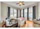 Bedroom with hardwood floors, large windows and ample natural light streaming through modern gray curtains at 119 Hemphill Ave, Chester, SC 29706