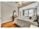 Bedroom with hardwood floors, bright windows with shelves, and charming dresser at 119 Hemphill Ave, Chester, SC 29706