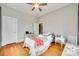 Bright bedroom with hardwood floors, featuring a comfortable bed and classic dresser, illuminated by a ceiling fan at 119 Hemphill Ave, Chester, SC 29706