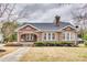 Charming brick home featuring a well-manicured lawn and cozy front porch with a porch swing at 119 Hemphill Ave, Chester, SC 29706