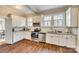 Bright kitchen with white cabinets, stainless steel appliances, and granite countertops at 119 Hemphill Ave, Chester, SC 29706