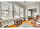Cozy sunroom featuring hardwood floors, multiple windows, and vintage decor at 119 Hemphill Ave, Chester, SC 29706