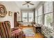 Bright sunroom with large windows, hardwood floors, and cozy seating at 119 Hemphill Ave, Chester, SC 29706