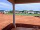 View of backyard from covered patio, showing a spacious lot and neighborhood homes at 13248 Chopin Ridge Rd, Huntersville, NC 28078