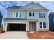 Two-story home featuring a two-car garage and a light blue exterior at 13248 Chopin Ridge Rd, Huntersville, NC 28078