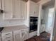 Bright kitchen features white cabinets, subway tile backsplash, and stainless double oven at 13248 Chopin Ridge Rd, Huntersville, NC 28078