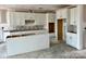 Unfinished kitchen featuring white cabinets and an island, awaiting appliances and finishing touches at 13248 Chopin Ridge Rd, Huntersville, NC 28078